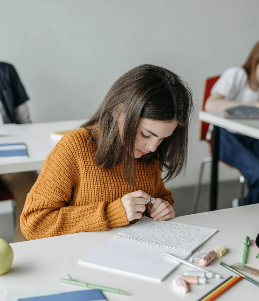 Add images to blog post that show students learning in a classroom.